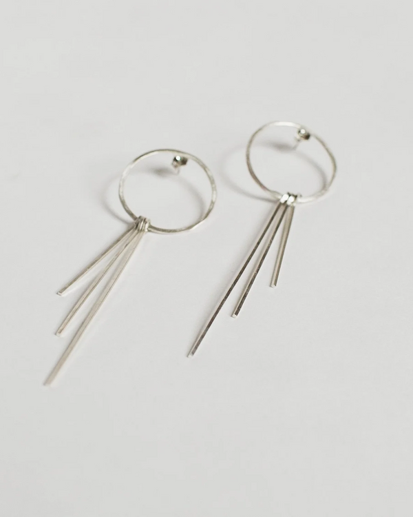 Sterling Silver hoop earrings with dangling silver strands on a light gray background