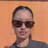 Girl modeling green sunglasses by Crap Eyewear